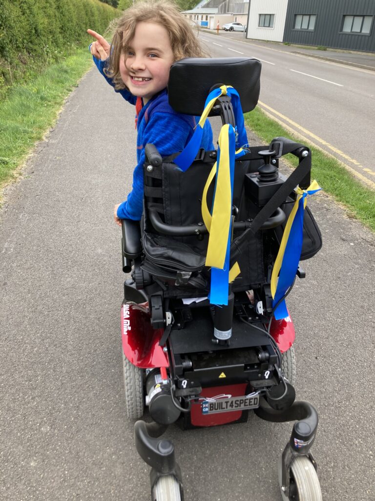 Jenson smiil;ing back in his power chair